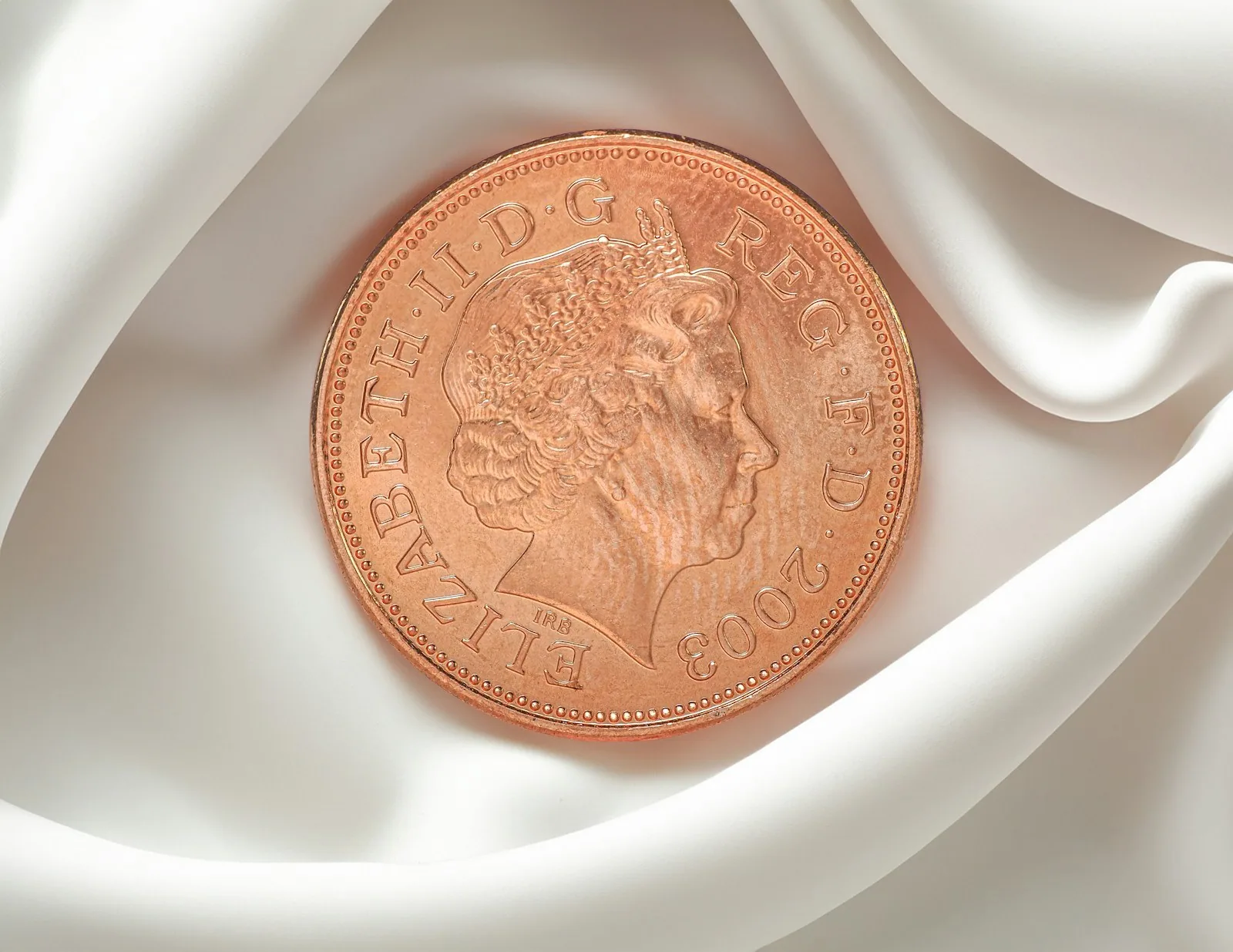 British one pence coin on a white background