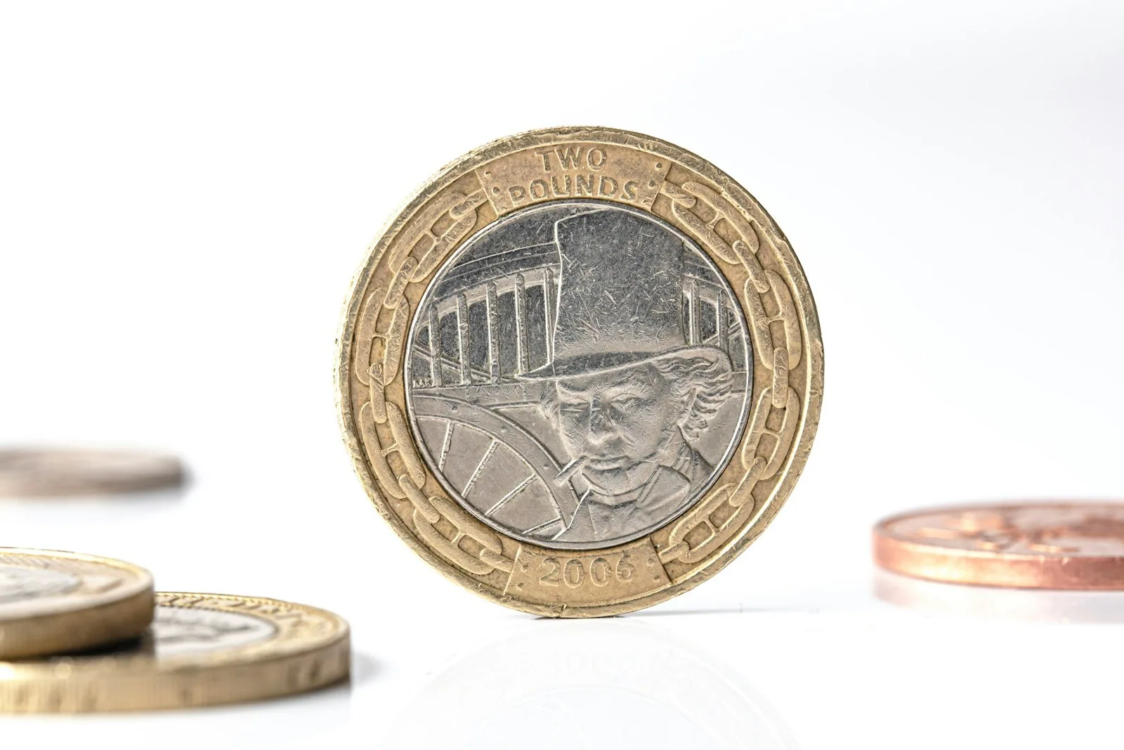 UK two pound coin standing upright on a white background